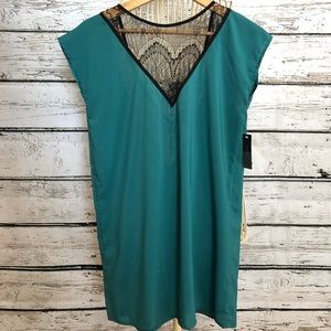 V neck top with black lace detail. Deep V in back